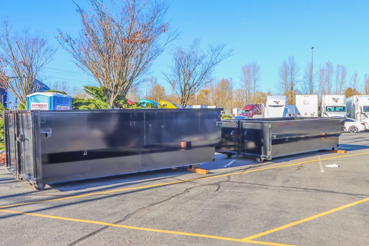 Professional dumpster rental service with roll-off container on residential driveway in New Berlin